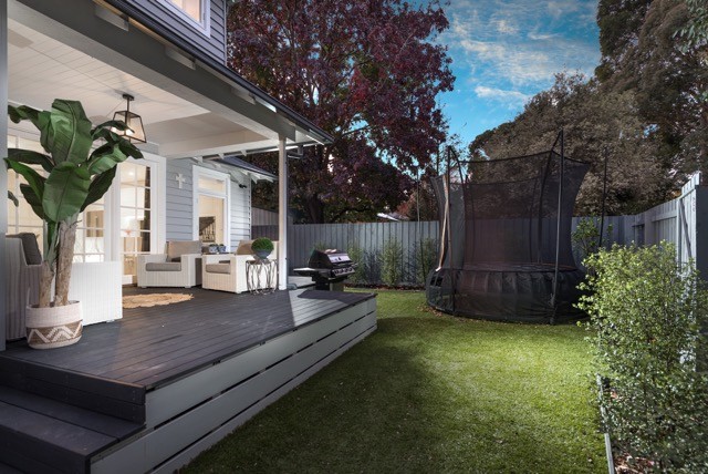Small traditional backyard patio in Sydney with decking and a roof extension.