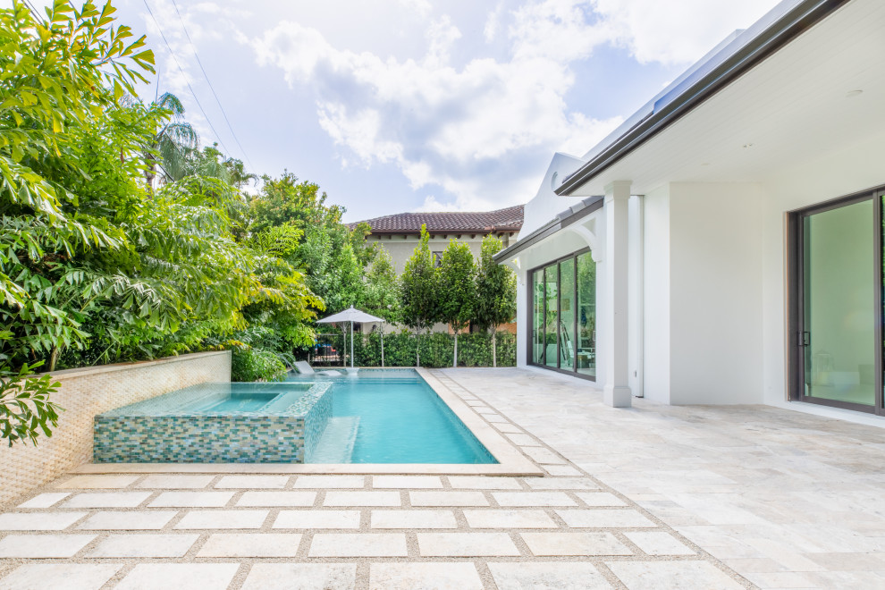 Photo of a transitional natural pool in Miami with with a pool and decking.