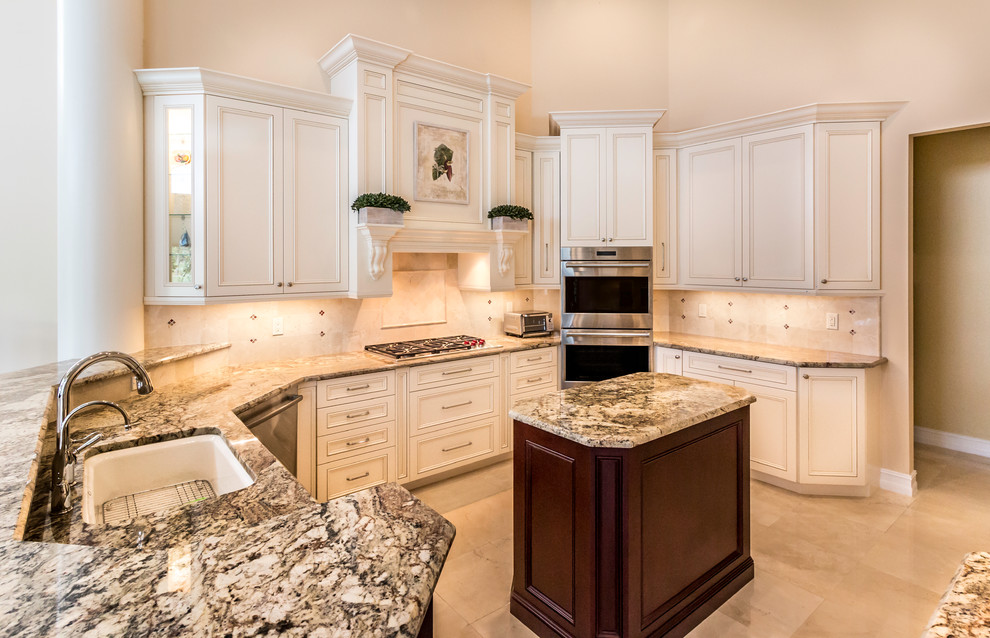 Large transitional u-shaped marble floor kitchen photo in Miami with a single-bowl sink, shaker cabinets, white cabinets, granite countertops, beige backsplash, glass sheet backsplash, stainless steel appliances and an island