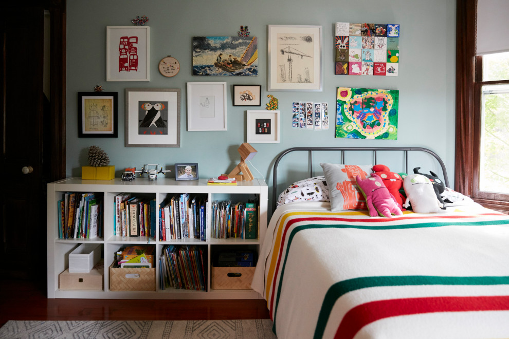 Photo of a traditional gender-neutral kids' bedroom for kids 4-10 years old in Other with grey walls, medium hardwood floors and brown floor.