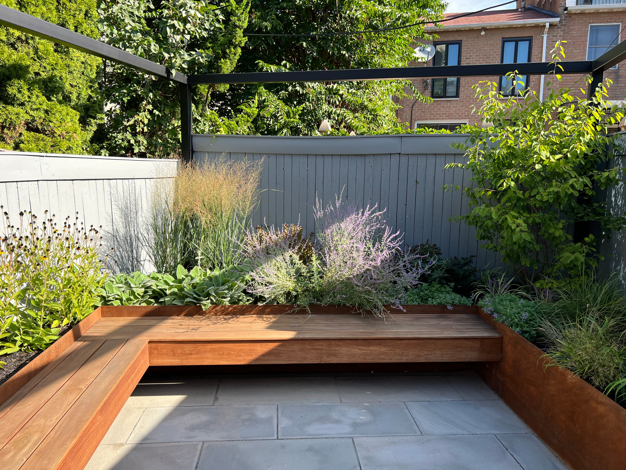 Paved patio with metal grating garden