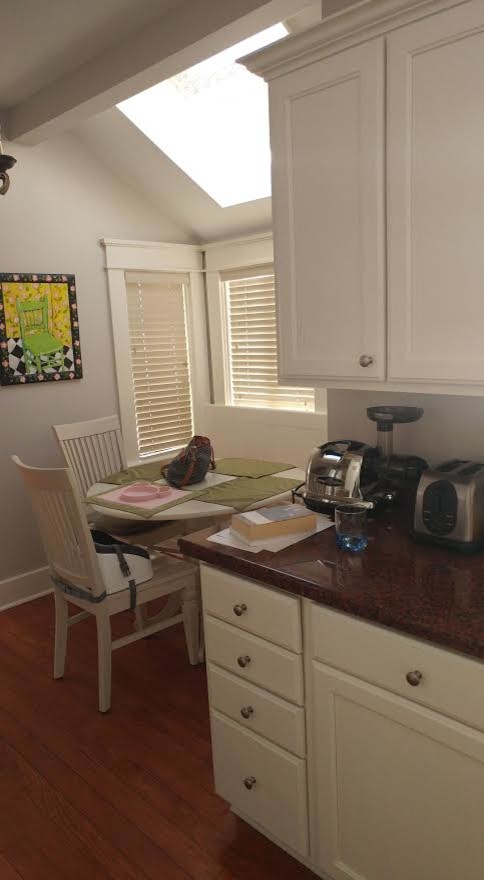 Mid-sized transitional l-shaped dark wood floor eat-in kitchen photo in Charlotte with a double-bowl sink, shaker cabinets, white cabinets, granite countertops, stainless steel appliances and an island