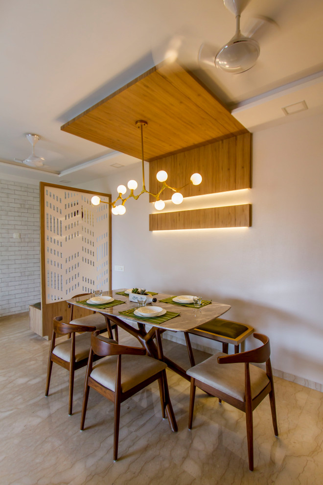 Inspiration for a mid-sized contemporary dining room in Mumbai with white walls and beige floor.