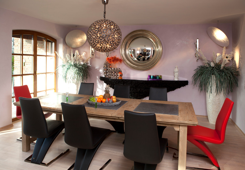 Design ideas for a large mediterranean dining room in Dusseldorf with multi-coloured walls and light hardwood floors.