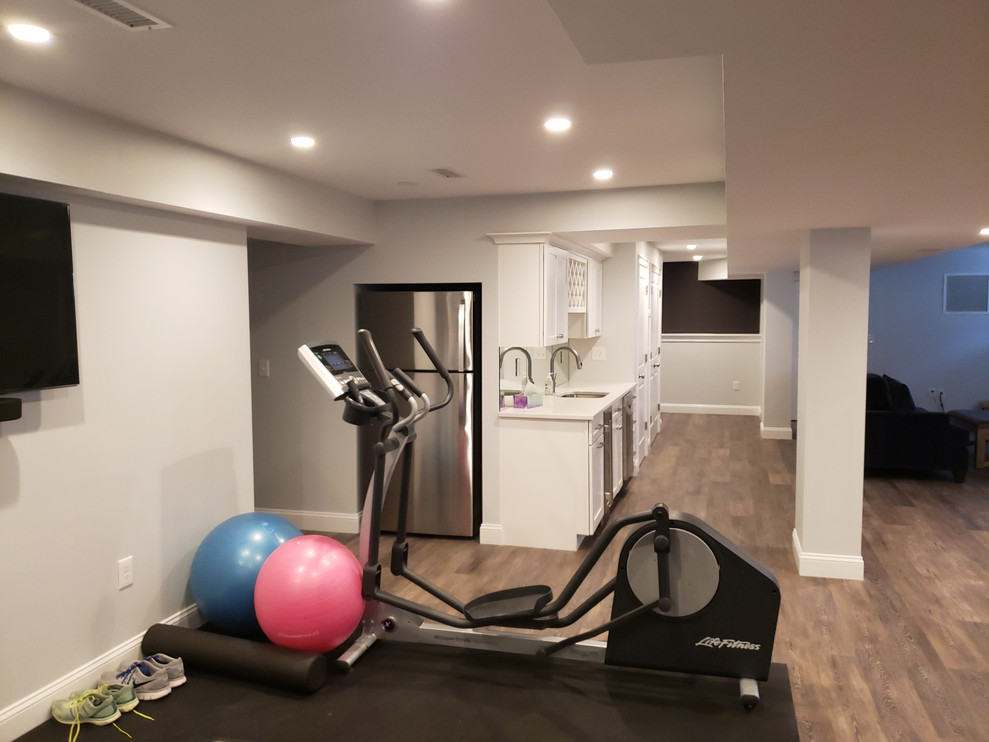 Inspiration for a small transitional home gym in Boston with grey walls, vinyl floors and black floor.