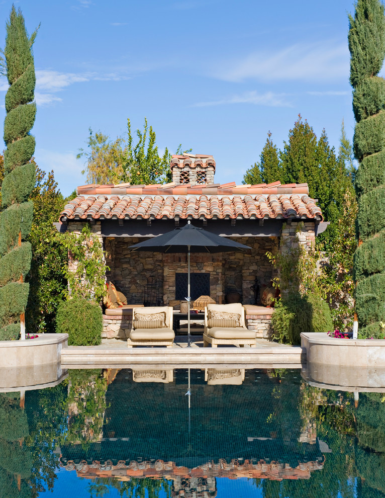 Design ideas for a mediterranean pool in Orange County with a pool house.