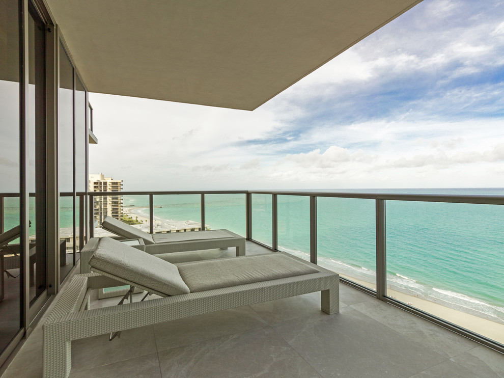 Mid-sized beach style balcony in Miami with a roof extension.