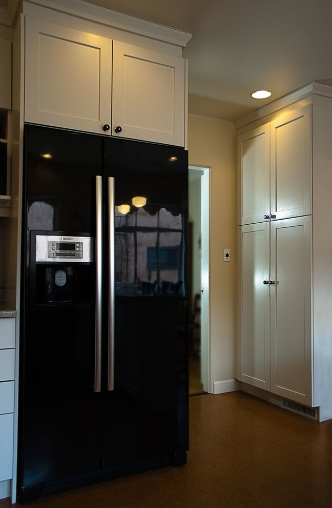 Inspiration for a small transitional u-shaped eat-in kitchen remodel in Orange County with an undermount sink, shaker cabinets, white cabinets, granite countertops, white backsplash, subway tile backsplash, colored appliances and a peninsula