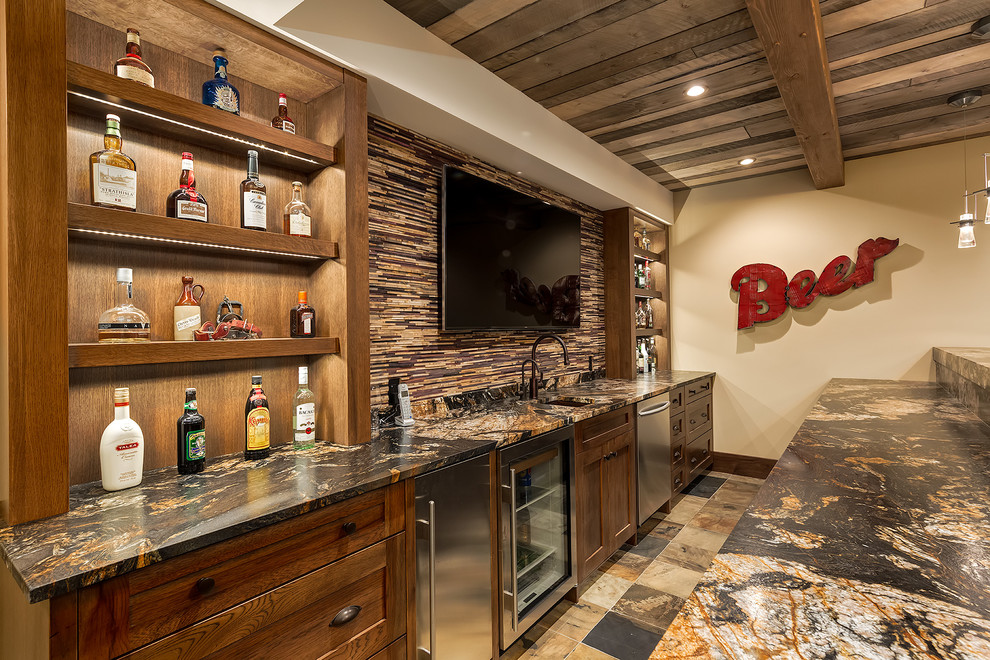 Inspiration for a large arts and crafts galley seated home bar in Calgary with an undermount sink, shaker cabinets, dark wood cabinets, granite benchtops, brown splashback, matchstick tile splashback and slate floors.
