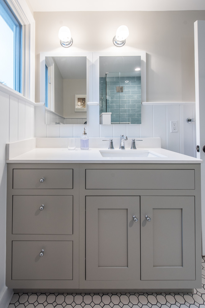 Inspiration for a mid-sized contemporary kids bathroom in DC Metro with recessed-panel cabinets, green cabinets, beige walls, mosaic tile floors, an undermount sink, engineered quartz benchtops and white floor.