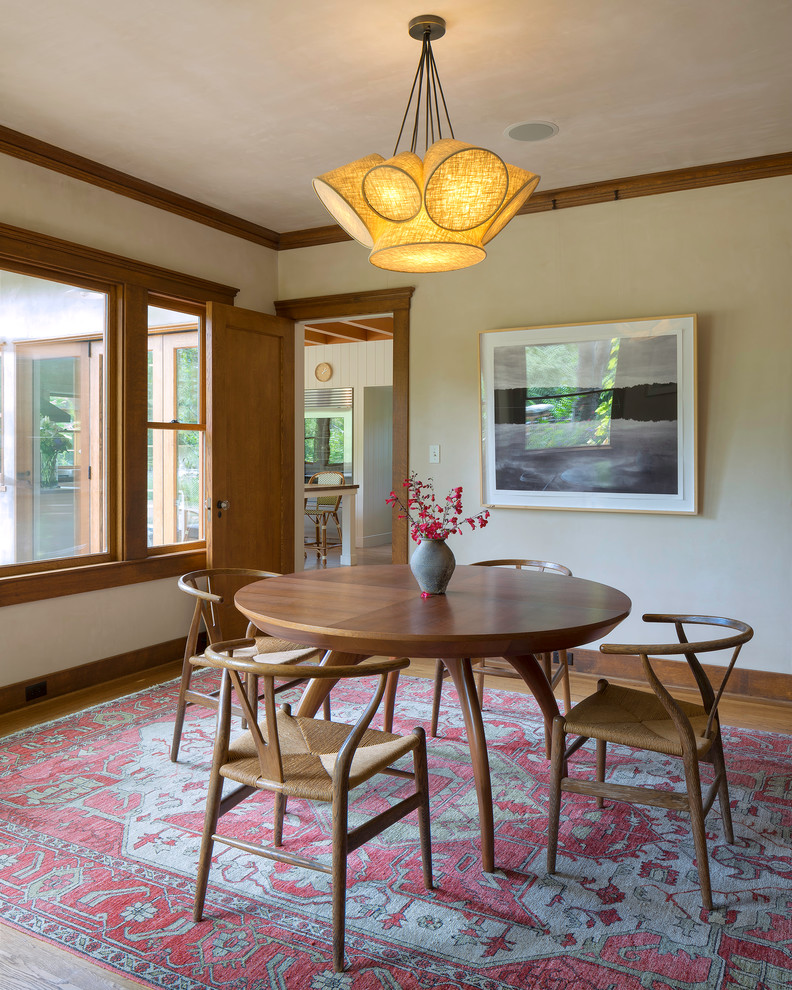Photo of a midcentury separate dining room in San Francisco with white walls and light hardwood floors.