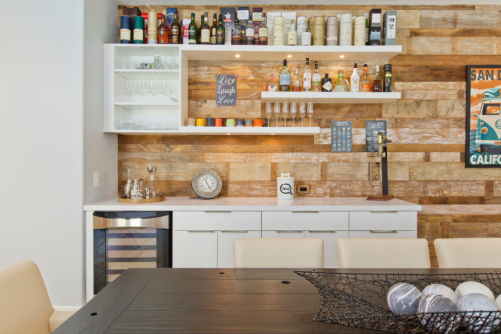 Photo of a mid-sized transitional single-wall wet bar in Tampa with flat-panel cabinets, white cabinets, quartz benchtops, light hardwood floors, brown floor, brown splashback and timber splashback.