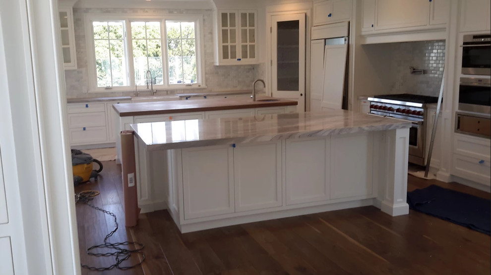 Example of a huge open concept kitchen design in Orange County with two islands