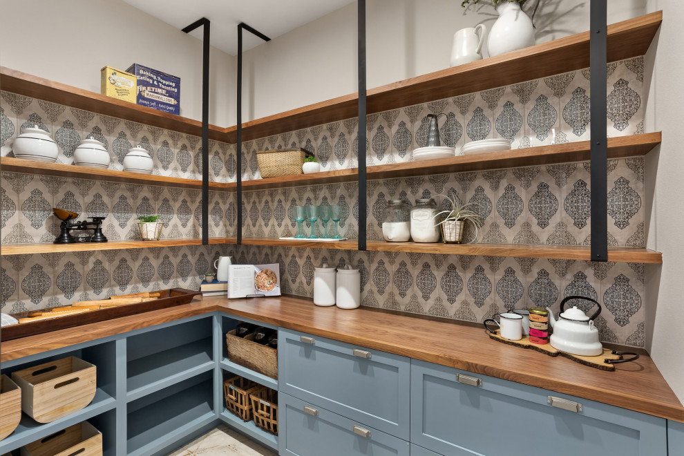 Design ideas for a large country laundry room in Portland with blue cabinets, wood benchtops, blue splashback, ceramic splashback, grey walls, ceramic floors, grey floor and brown benchtop.