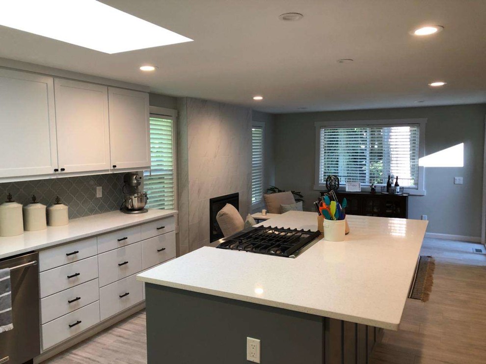 Eat-in kitchen - mid-sized transitional u-shaped porcelain tile and gray floor eat-in kitchen idea in Seattle with an undermount sink, recessed-panel cabinets, white cabinets, quartzite countertops, gray backsplash, ceramic backsplash, stainless steel appliances, an island and white countertops