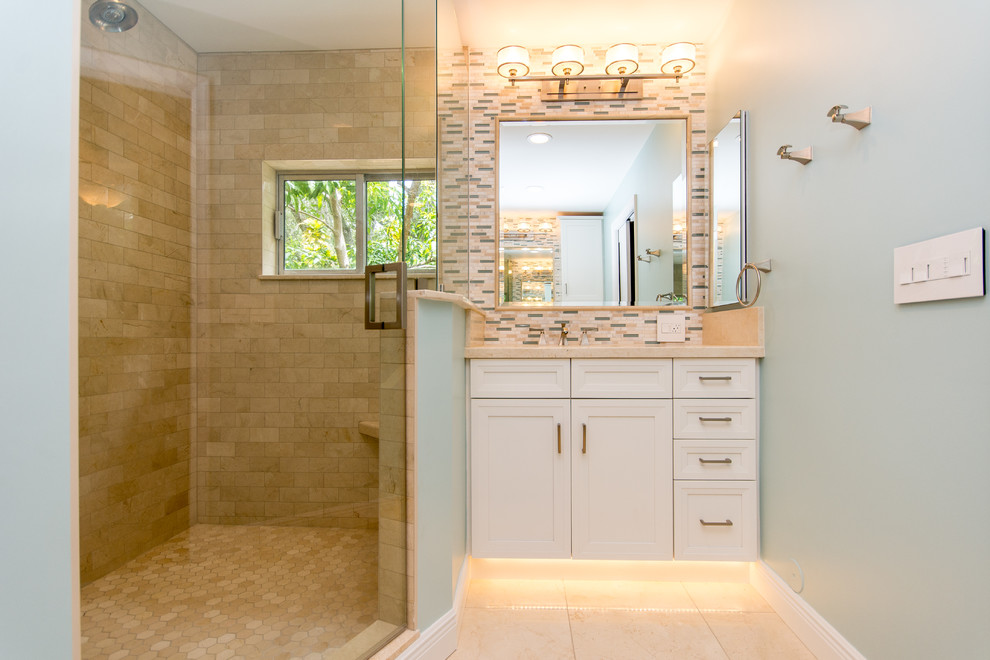 This is an example of a mid-sized transitional master bathroom in Miami with an undermount sink, white cabinets, an alcove shower, beige tile, ceramic tile, blue walls and ceramic floors.