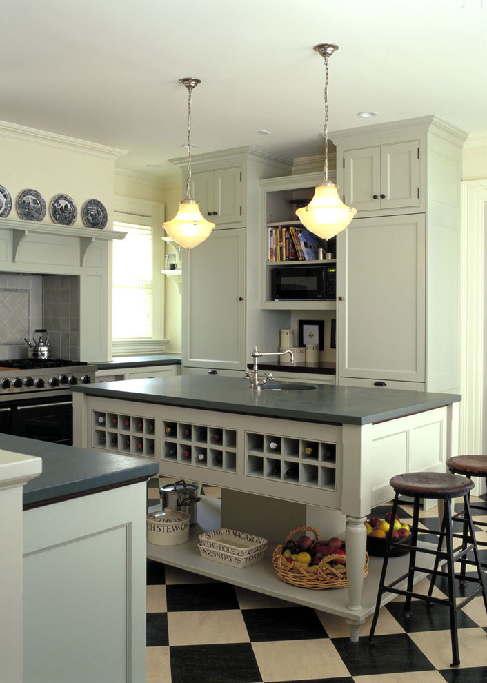 This is an example of a traditional kitchen in Burlington with recessed-panel cabinets, grey cabinets, black appliances and grey splashback.