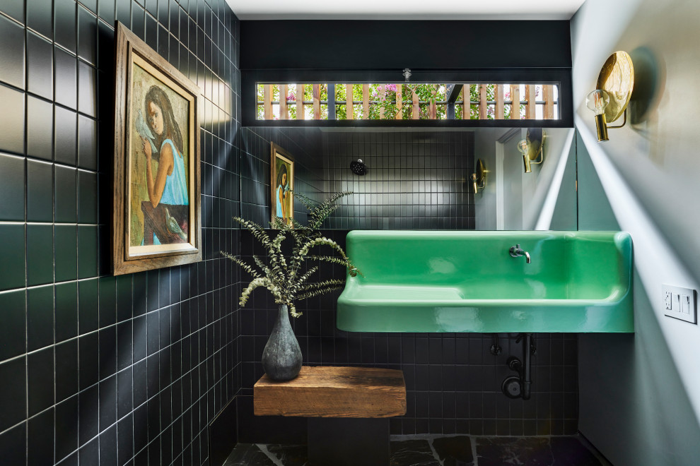 Design ideas for a mid-sized modern 3/4 wet room bathroom in Los Angeles with green cabinets, a one-piece toilet, black tile, ceramic tile, blue walls, slate floors, a wall-mount sink, black floor, green benchtops, a niche, a single vanity and a floating vanity.