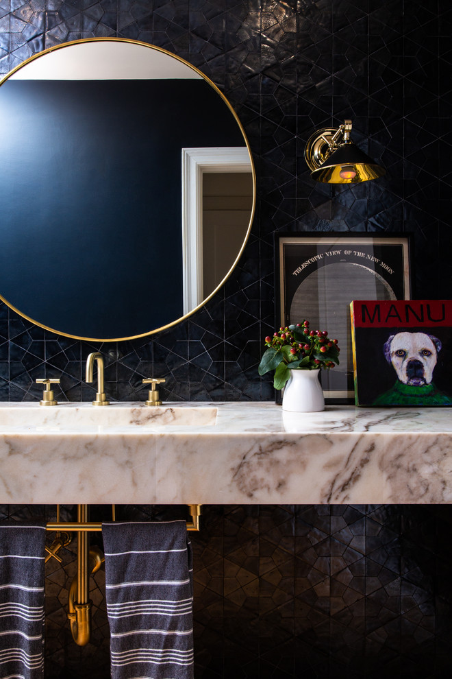 Inspiration for a transitional powder room in Los Angeles with black tile, an integrated sink, marble benchtops and multi-coloured benchtops.