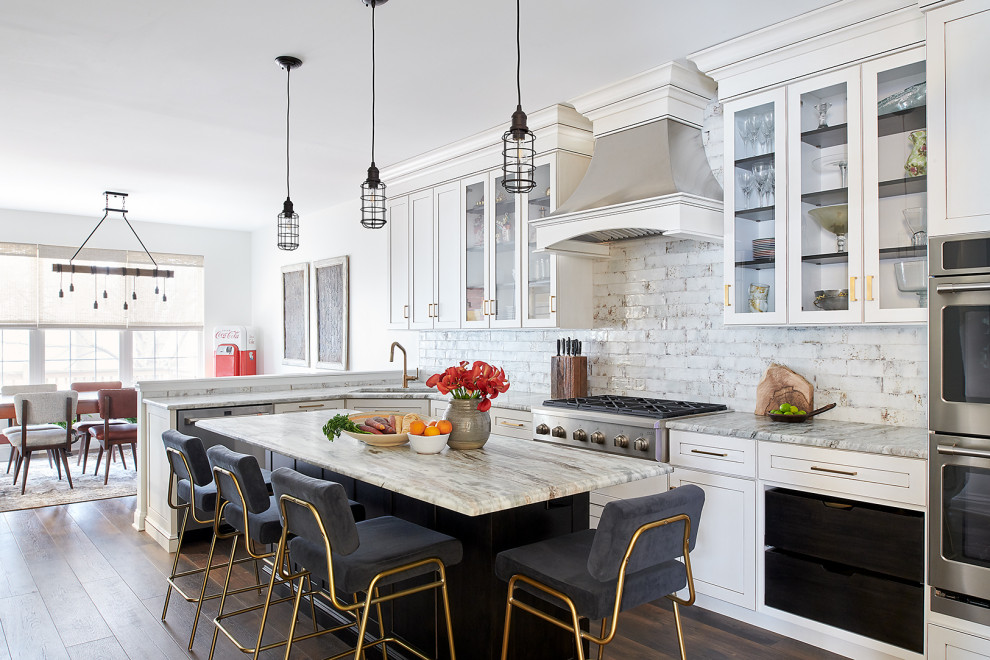 Eat-in kitchen - large eclectic l-shaped dark wood floor and brown floor eat-in kitchen idea in Philadelphia with an undermount sink, shaker cabinets, white cabinets, granite countertops, white backsplash, ceramic backsplash, stainless steel appliances, an island and beige countertops
