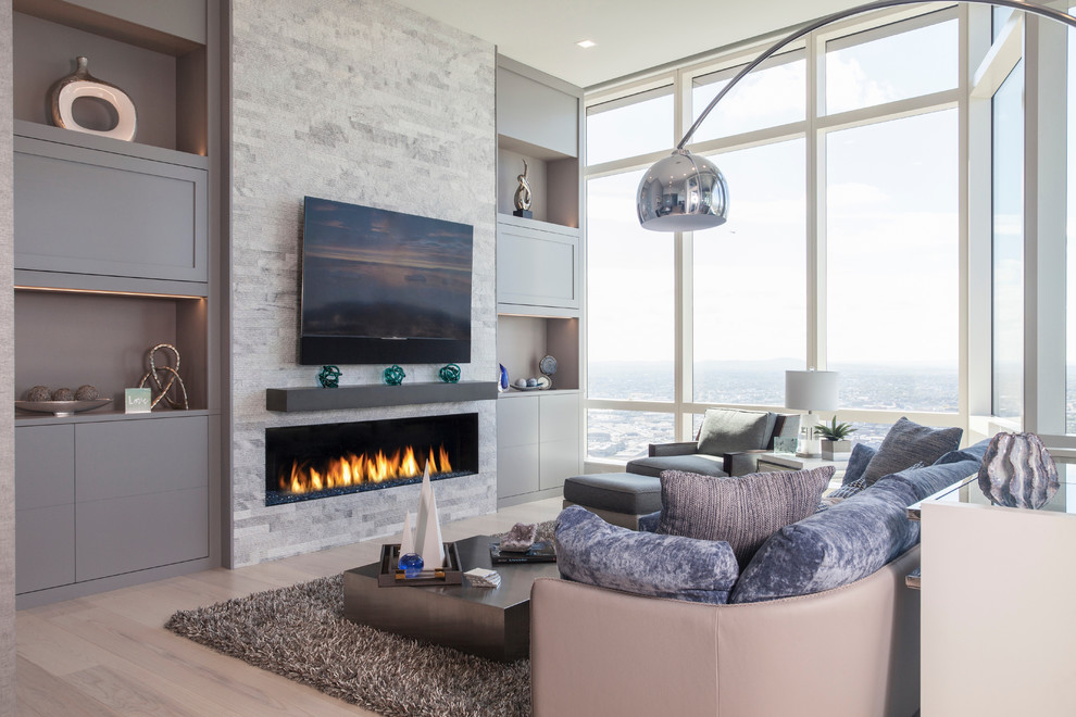 Living room - contemporary light wood floor and beige floor living room idea in Boston with a ribbon fireplace and a stone fireplace