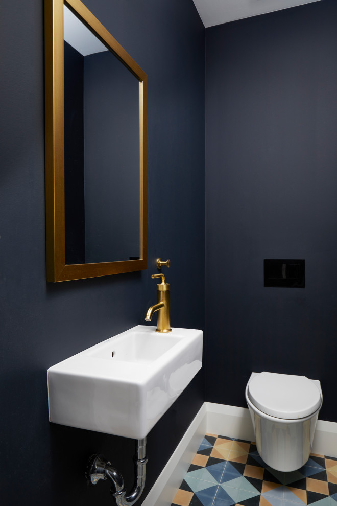 Large transitional powder room in Toronto with a wall-mount toilet, blue walls, porcelain floors, a wall-mount sink and multi-coloured floor.