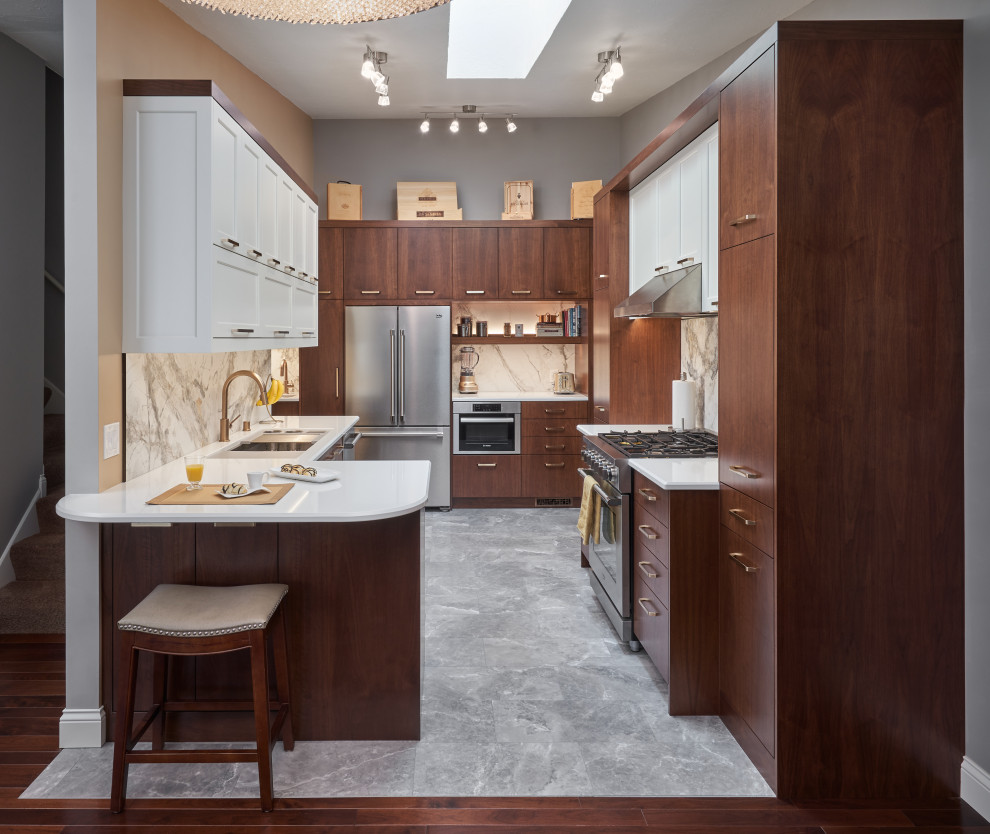 Contemporary u-shaped kitchen in Minneapolis with an undermount sink, flat-panel cabinets, medium wood cabinets, quartz benchtops, multi-coloured splashback, marble splashback, stainless steel appliances, a peninsula, grey floor and white benchtop.