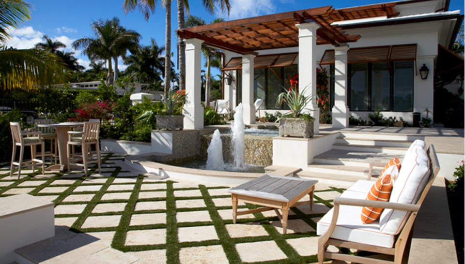 Inspiration for a tropical patio in Miami with a pergola.