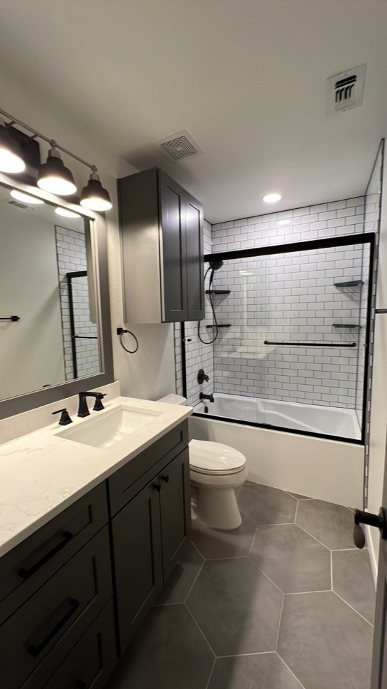 Bathroom - country porcelain tile, gray floor and single-sink bathroom idea in Austin with gray cabinets, an undermount sink, quartz countertops and white countertops