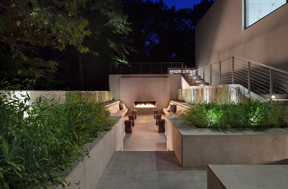 Large modern courtyard patio in New York with a fire feature, concrete slab and no cover.