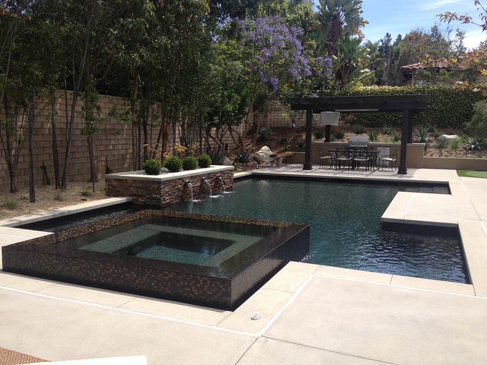 Design ideas for a mid-sized modern backyard rectangular lap pool in San Diego with a hot tub.