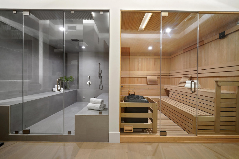 На фото: огромная баня и сауна в стиле модернизм с душевой комнатой, серой плиткой, керамогранитной плиткой, белыми стенами, полом из керамогранита, душем с распашными дверями, сиденьем для душа, деревянным потолком и деревянными стенами