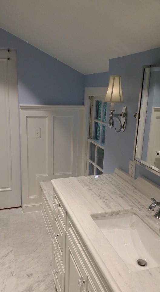 Inspiration for a traditional master bathroom in Other with a corner shower, white tile, stone slab, granite benchtops, raised-panel cabinets, white cabinets, a two-piece toilet, an undermount sink, purple walls and marble floors.