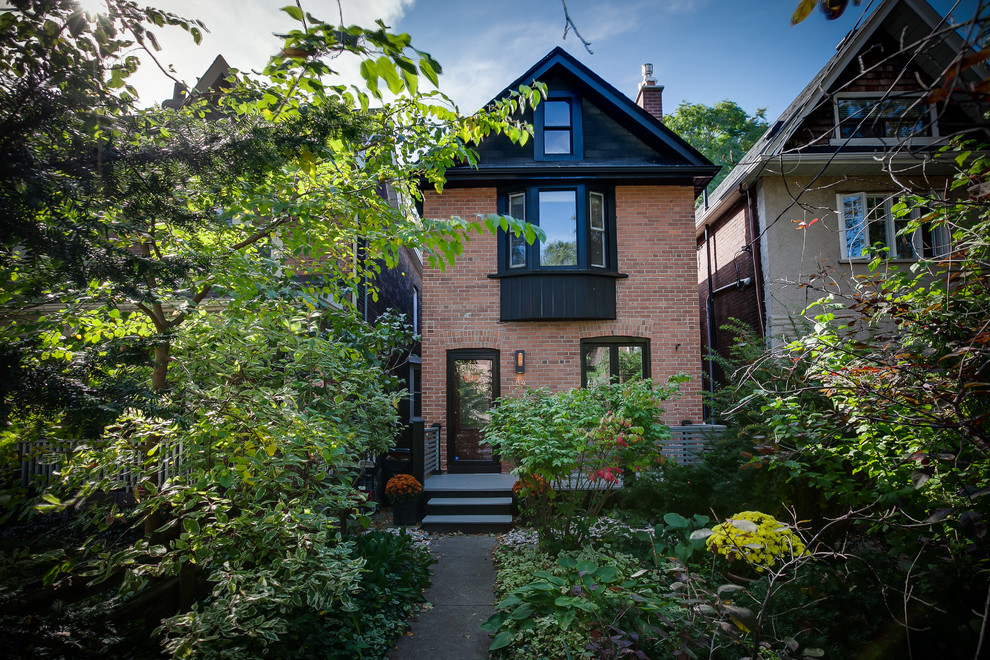 Inspiration for a traditional two-storey brick red exterior in Toronto.