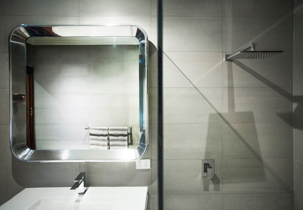 Inspiration for a mid-sized eclectic master bathroom in Perth with furniture-like cabinets, white cabinets, an open shower, gray tile, porcelain tile, grey walls, porcelain floors, an integrated sink, engineered quartz benchtops and grey floor.