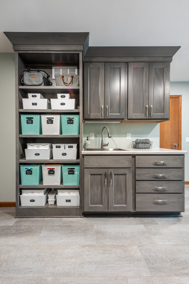 Inspiration for a large contemporary u-shaped utility room in Other with an utility sink, shaker cabinets, brown cabinets, laminate benchtops, blue walls, vinyl floors, a side-by-side washer and dryer and grey benchtop.