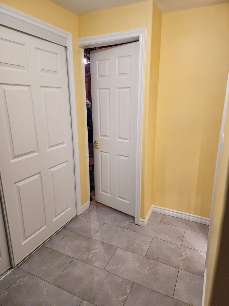 На фото: коридор среднего размера в стиле модернизм с желтыми стенами, полом из винила и серым полом с