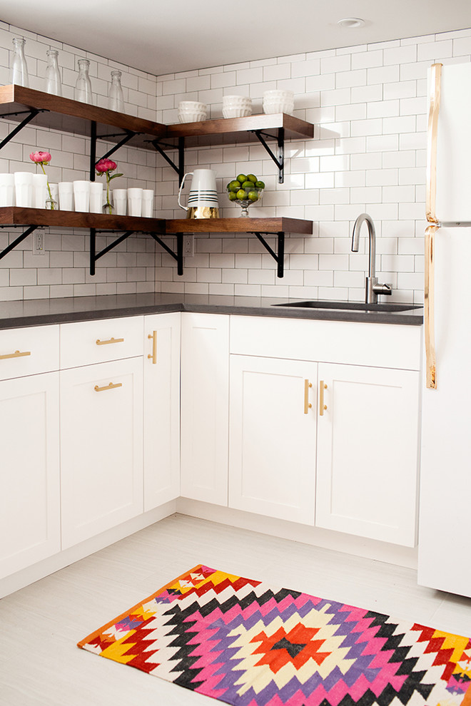 Inspiration for a transitional l-shaped kitchen in New York with ceramic floors, shaker cabinets, white cabinets, white splashback and subway tile splashback.