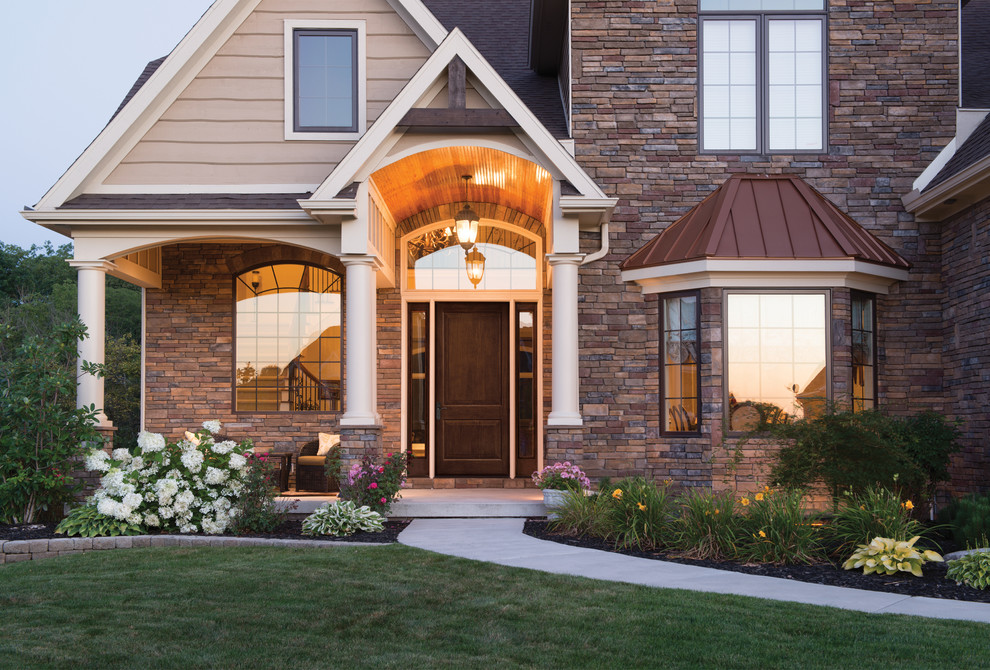 Example of a large transitional front door design in Toronto with a dark wood front door