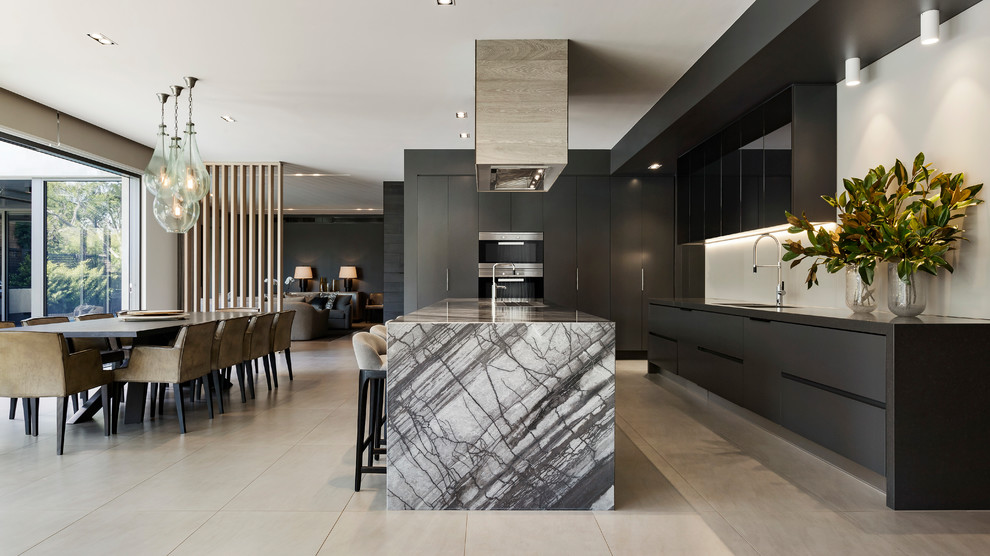 Contemporary galley eat-in kitchen in Melbourne with an undermount sink, flat-panel cabinets, black cabinets, white splashback, black appliances and with island.
