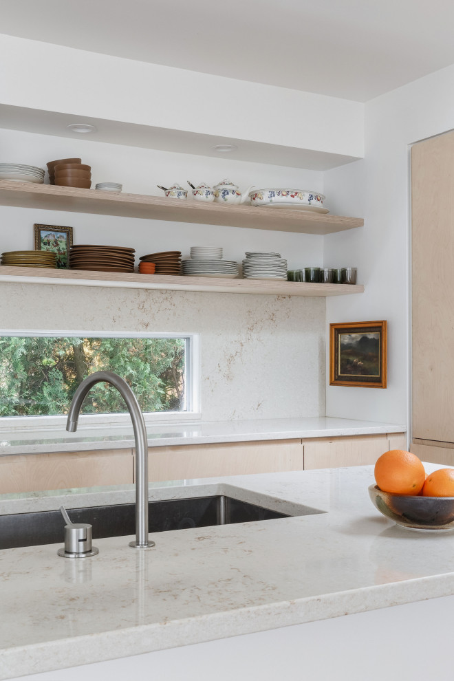 Eat-in kitchen - mid-sized modern galley eat-in kitchen idea with flat-panel cabinets, an island, an undermount sink, beige cabinets, quartz countertops, multicolored backsplash, quartz backsplash and multicolored countertops