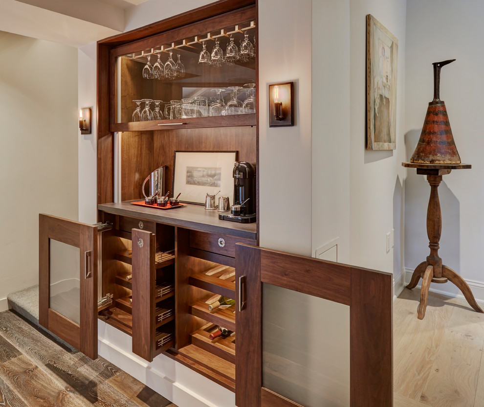Inspiration for a transitional single-wall home bar in Chicago with glass-front cabinets, medium wood cabinets, brown splashback, timber splashback, medium hardwood floors, brown floor and grey benchtop.