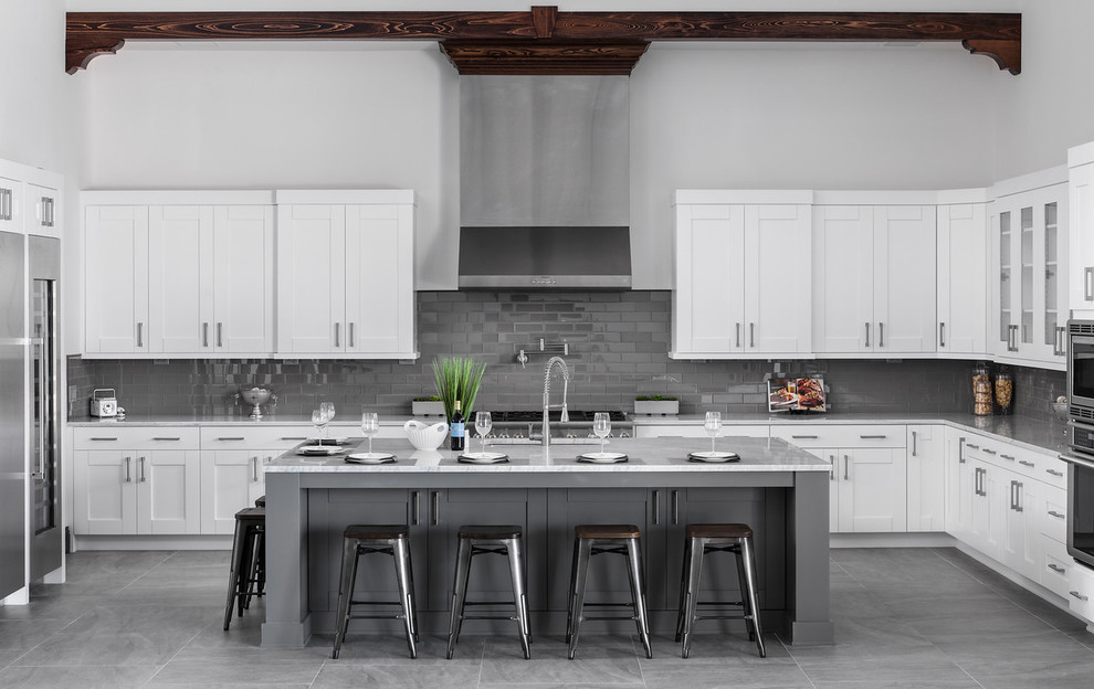 Inspiration for a transitional u-shaped kitchen in Orlando with an undermount sink, shaker cabinets, white cabinets, granite benchtops, grey splashback, stainless steel appliances, porcelain floors, with island, grey floor, subway tile splashback and grey benchtop.