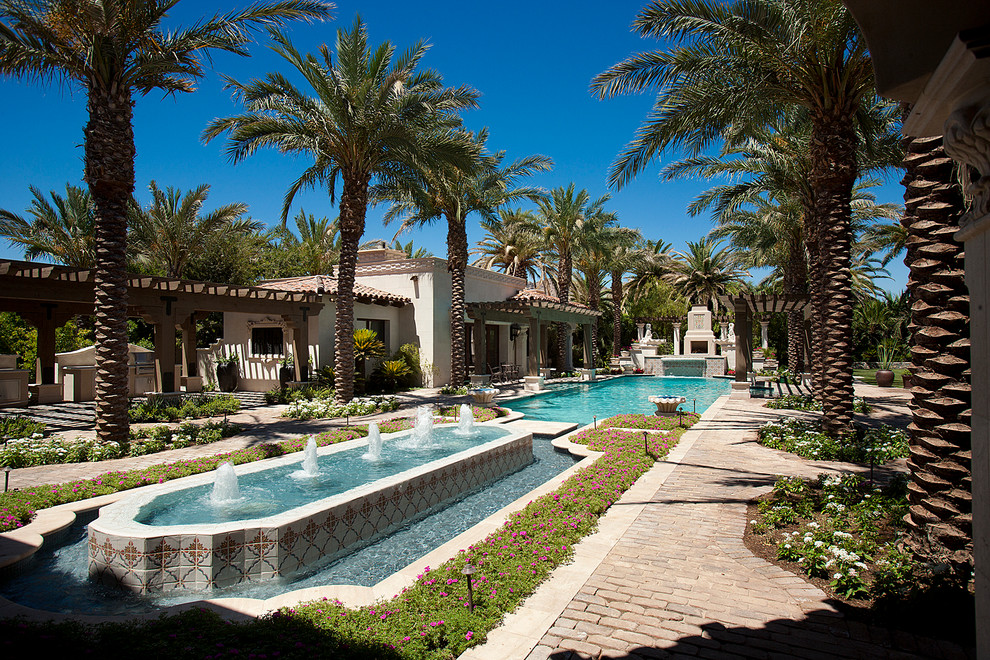 Huge transitional backyard brick and rectangular pool fountain photo in Phoenix