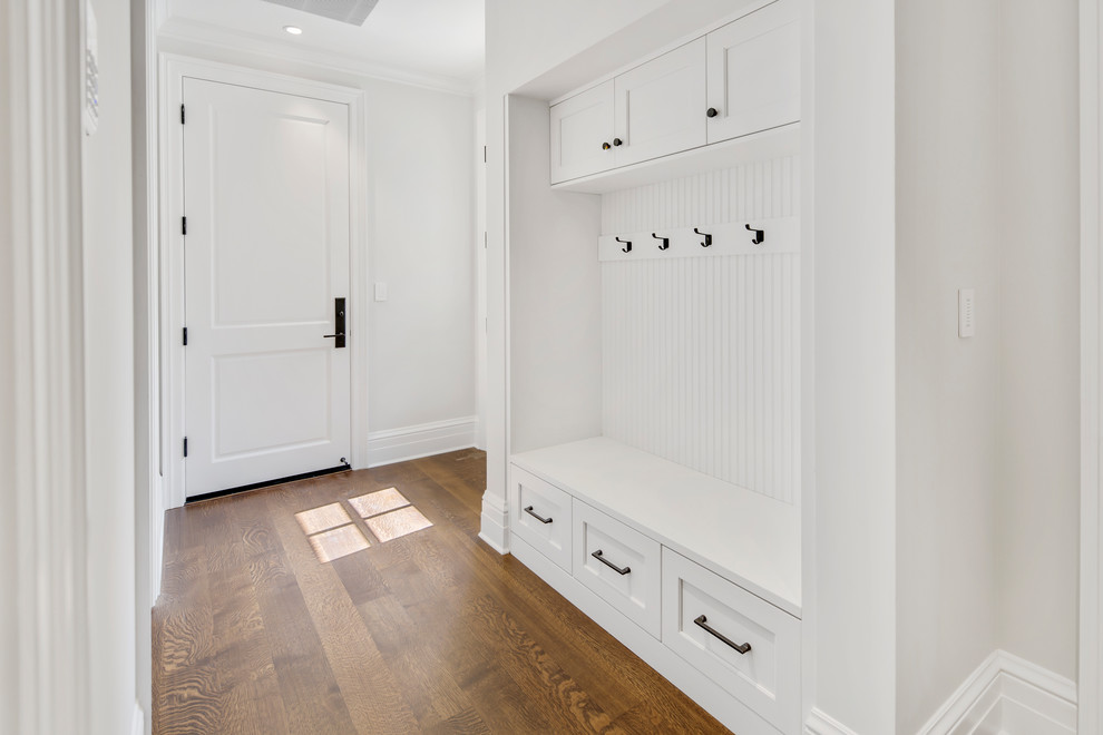 Mudroom - mid-sized transitional medium tone wood floor and brown floor mudroom idea in San Francisco with gray walls