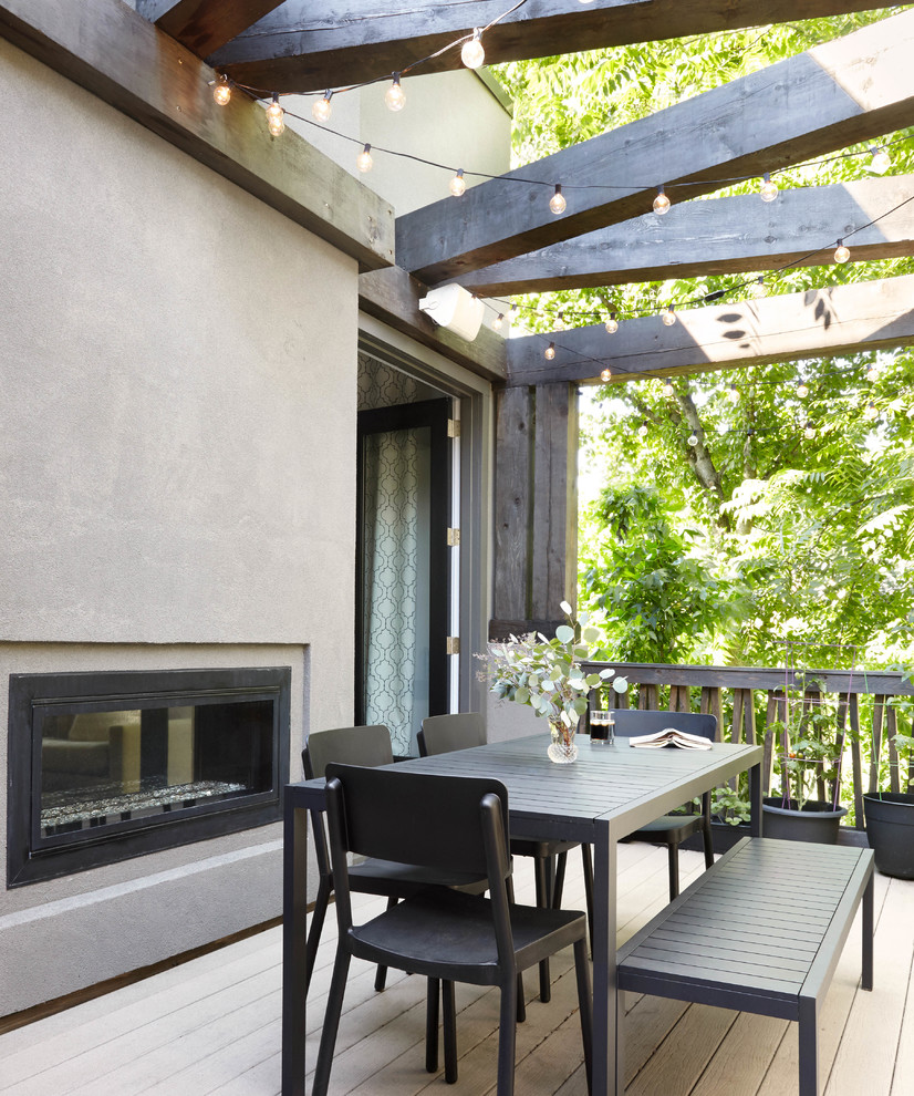 Photo of a large contemporary backyard verandah in Nashville with a fire feature.
