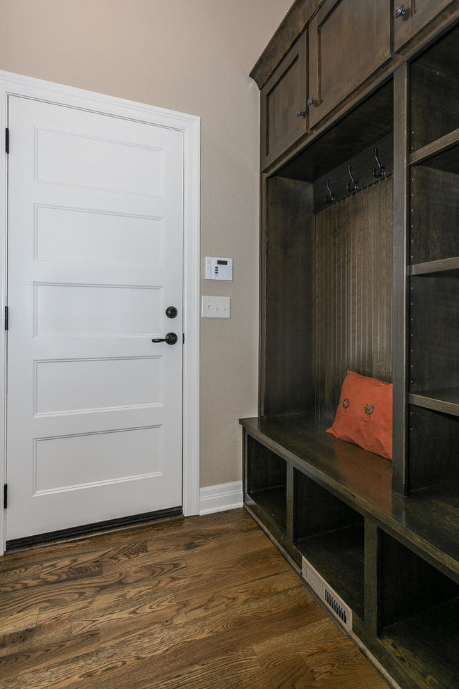 This is an example of a mid-sized contemporary mudroom in Orange County with beige walls, medium hardwood floors, a single front door and a white front door.