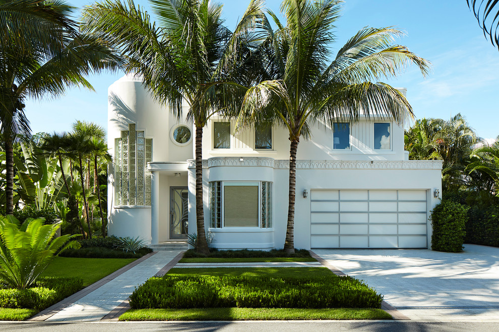 Design ideas for a contemporary two-storey stucco white exterior in Miami with a flat roof.