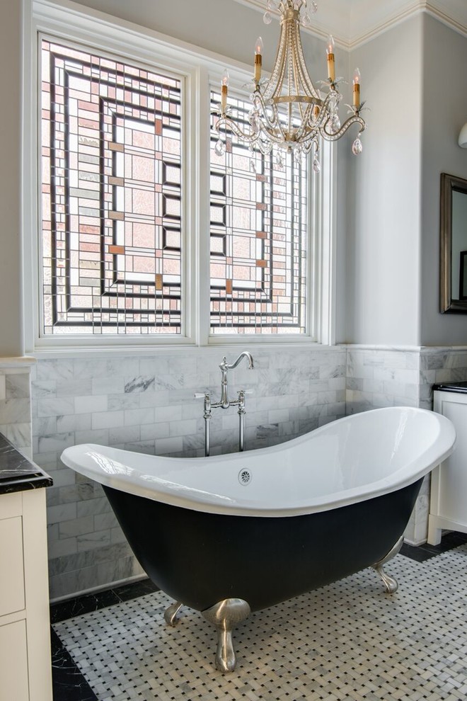 Inspiration for a mid-sized traditional master bathroom in Charlotte with white cabinets, a claw-foot tub, black and white tile, white tile, grey walls, mosaic tile floors, marble benchtops, a one-piece toilet, a vessel sink, recessed-panel cabinets and multi-coloured floor.