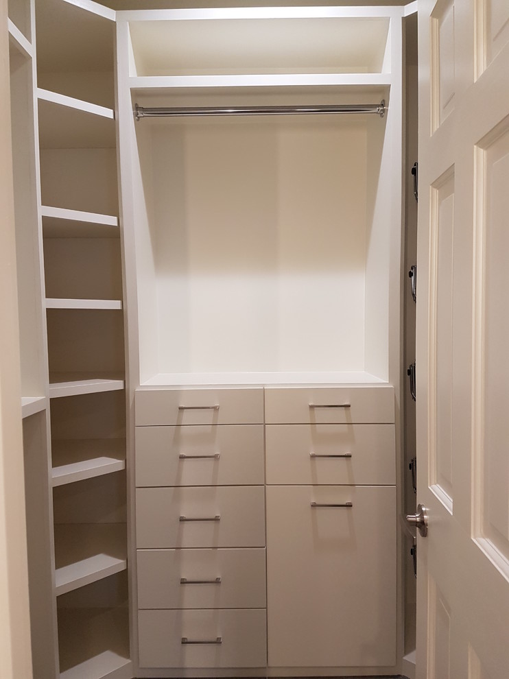 Design ideas for a large asian men's walk-in wardrobe in Houston with flat-panel cabinets, white cabinets, porcelain floors and grey floor.